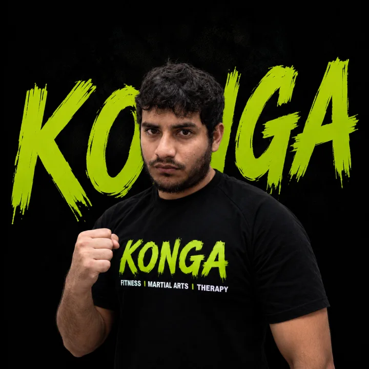 Coach Javier holding a boxing stance in front of the Konga logo
