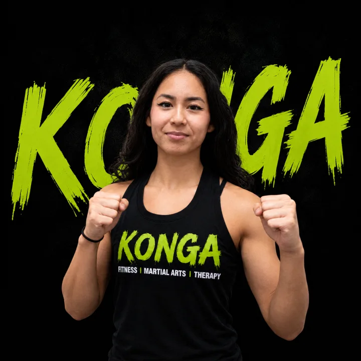 Coach Leah holding a boxing stance in front of the Konga logo