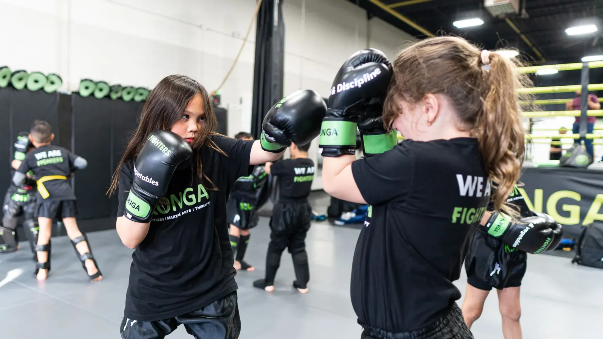 Two children practising punches and defensive positioning