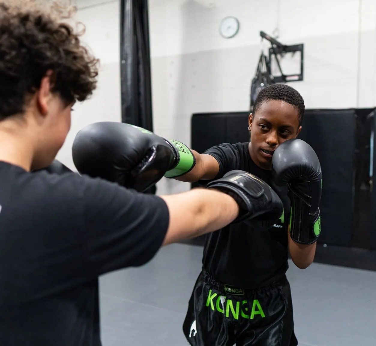 Coach guiding a child's boxing technique