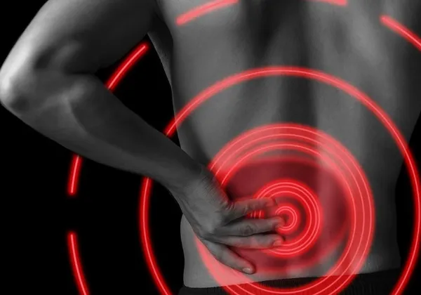Person holding their lower back, highlighted with red rings