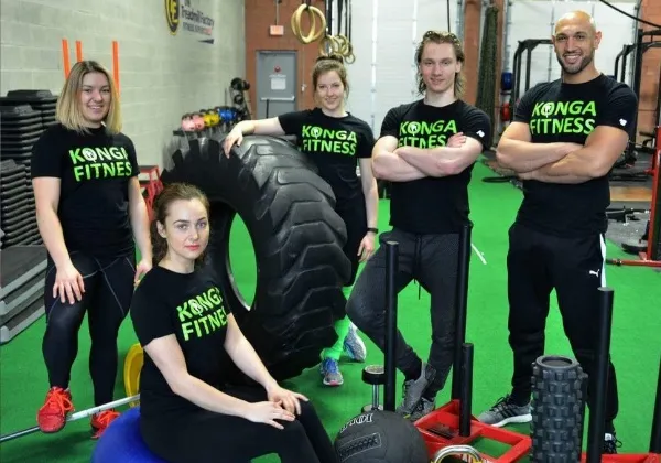 Konga Fitness team posing beside a large training tyre