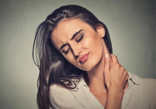 Woman holding the side of her neck