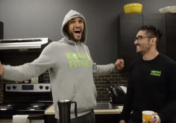 Two men discussing post-workout nutrition in a kitchen