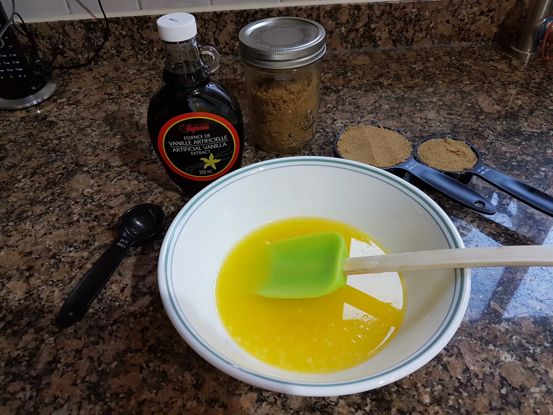Melted butter in a mixing bowl beside the carmelita ingredients