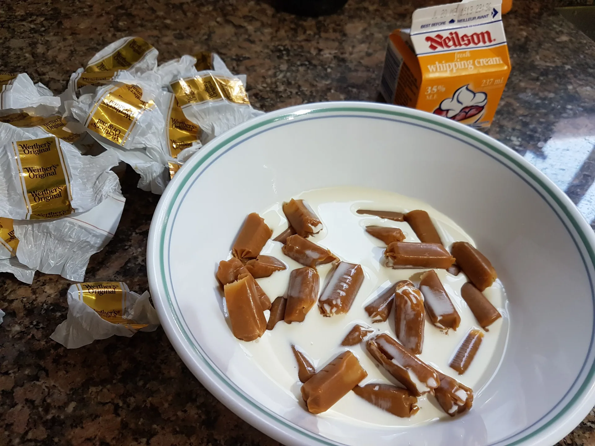 Unwrapped caramels in a bowl with cream
