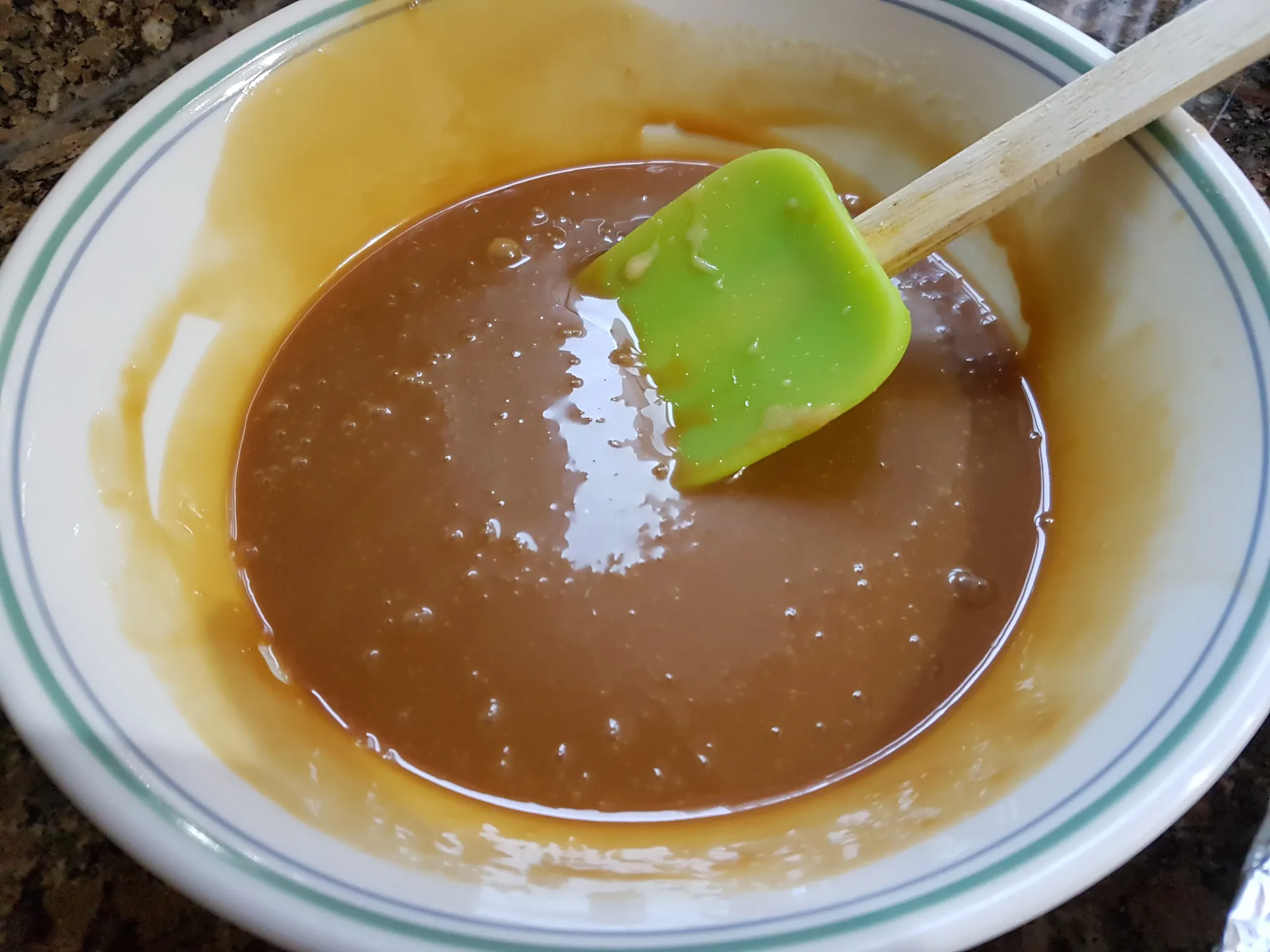 Melted caramel stirred with a green spatula