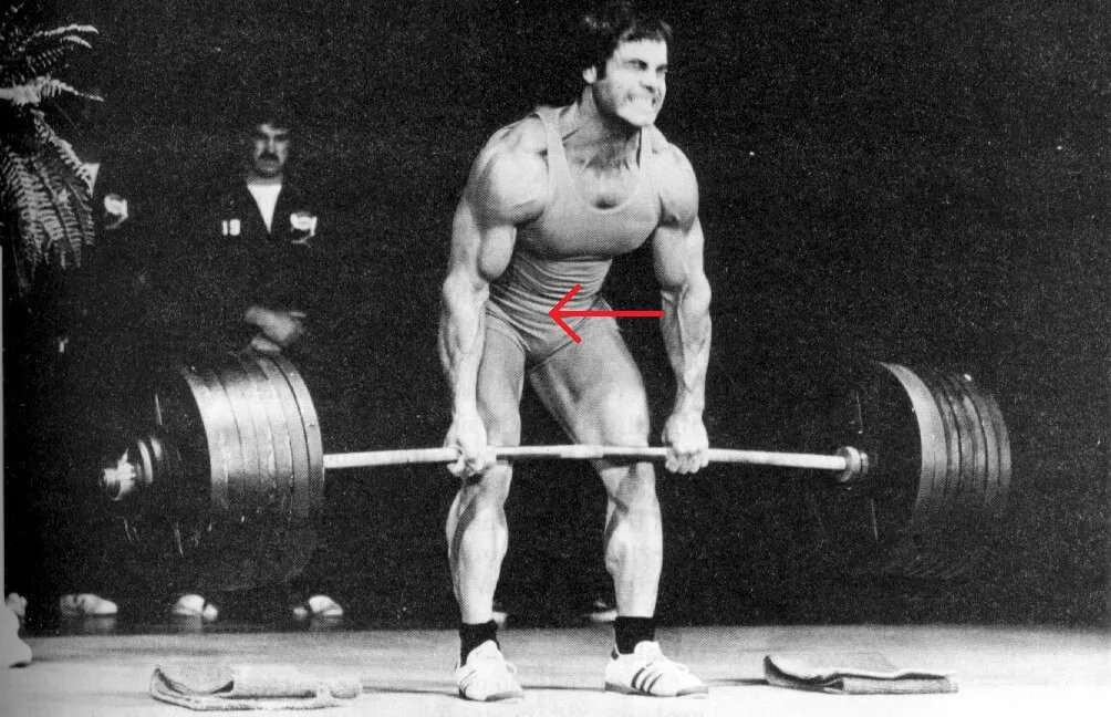 Weightlifter raising a barbell during a deadlift