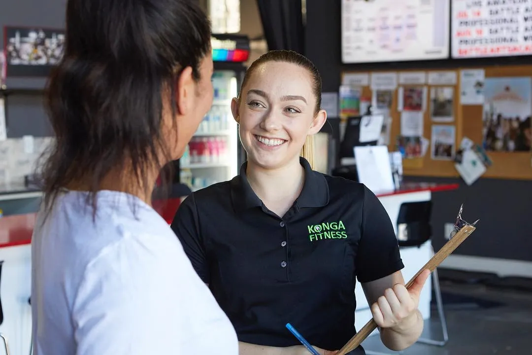 Konga staff member welcoming a visitor with a clipboard