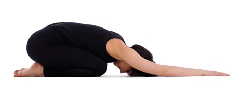 Person resting in child's pose with arms extended forward
