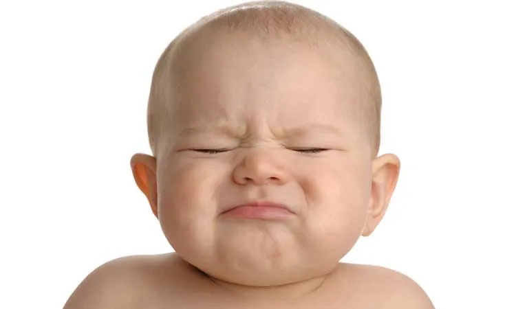 Baby making a strained facial expression