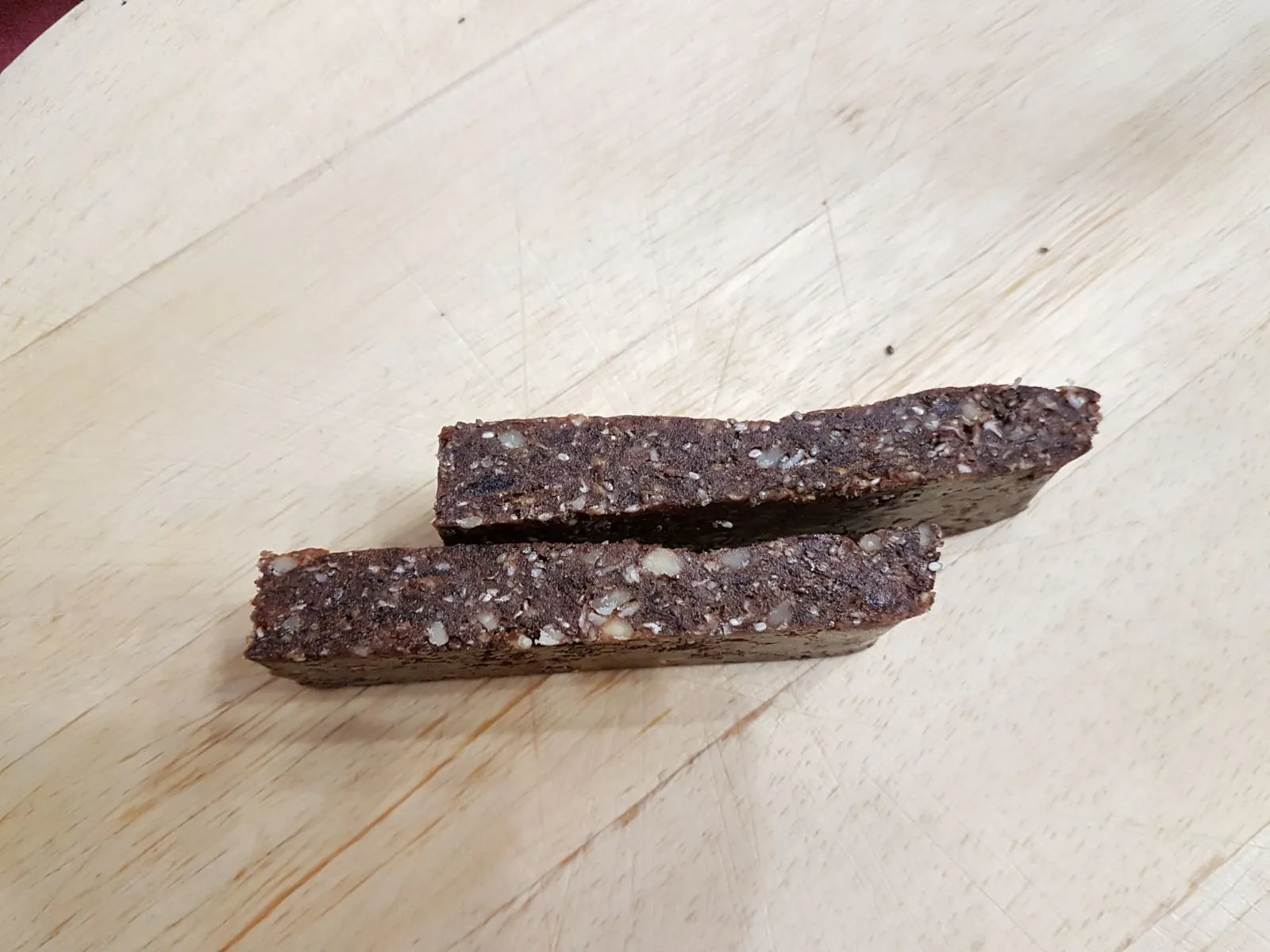 Two homemade snack bars on a wooden surface