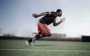 Athlete sprinting across a sports field