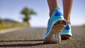 Close-up of running shoes on a paved path
