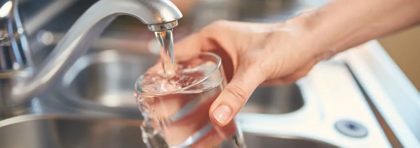 Glass being filled with water from a tap