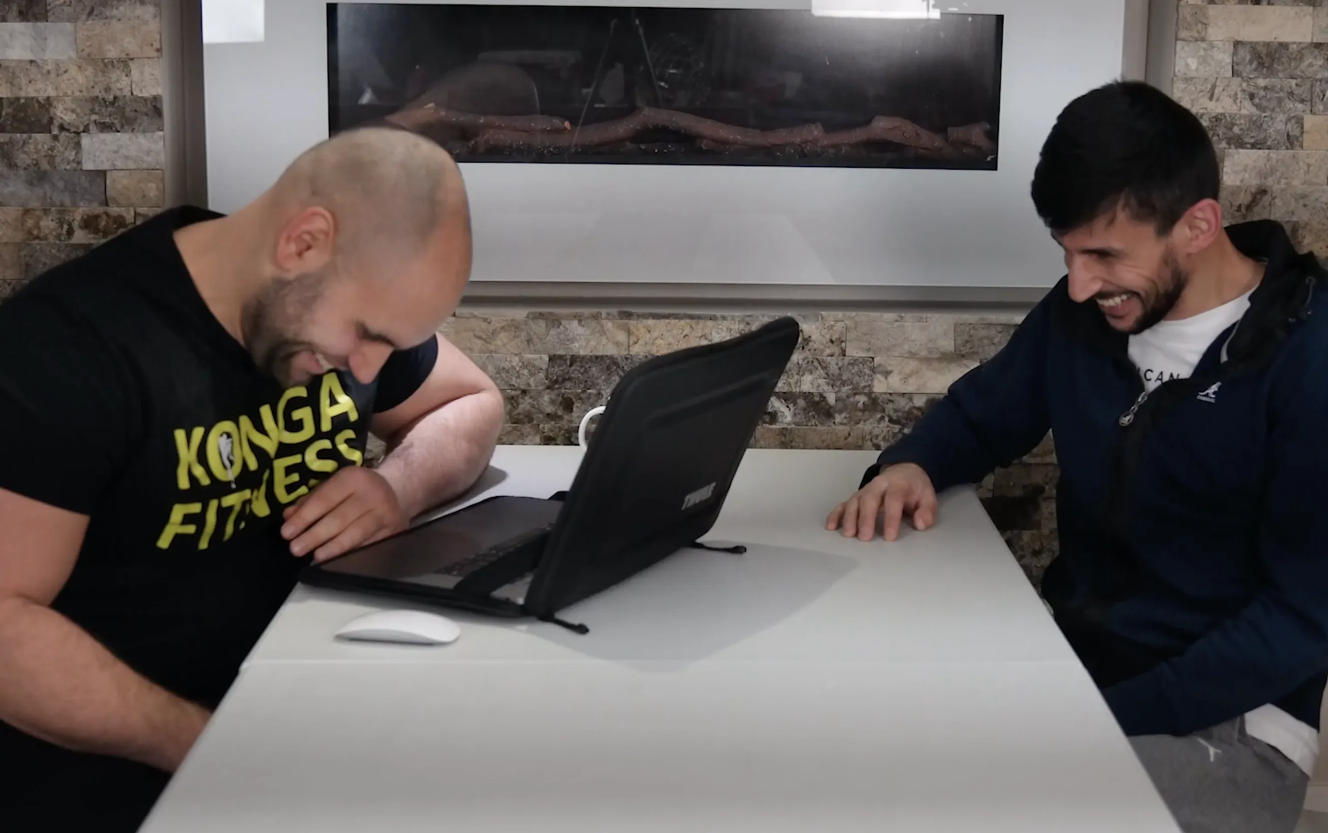 Two Konga staff members reviewing information on a laptop