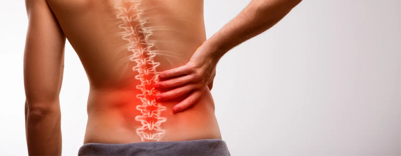 Person holding their lower back with the spine highlighted in red