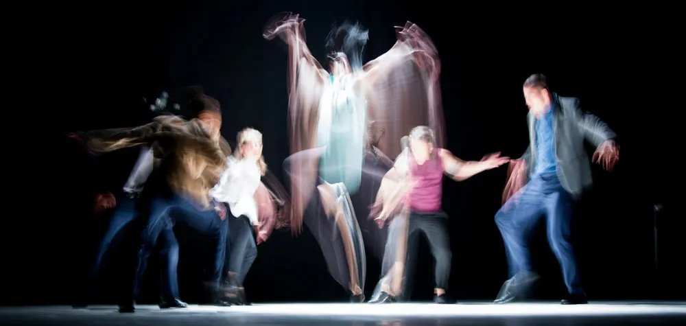 Long-exposure photograph capturing several people in motion