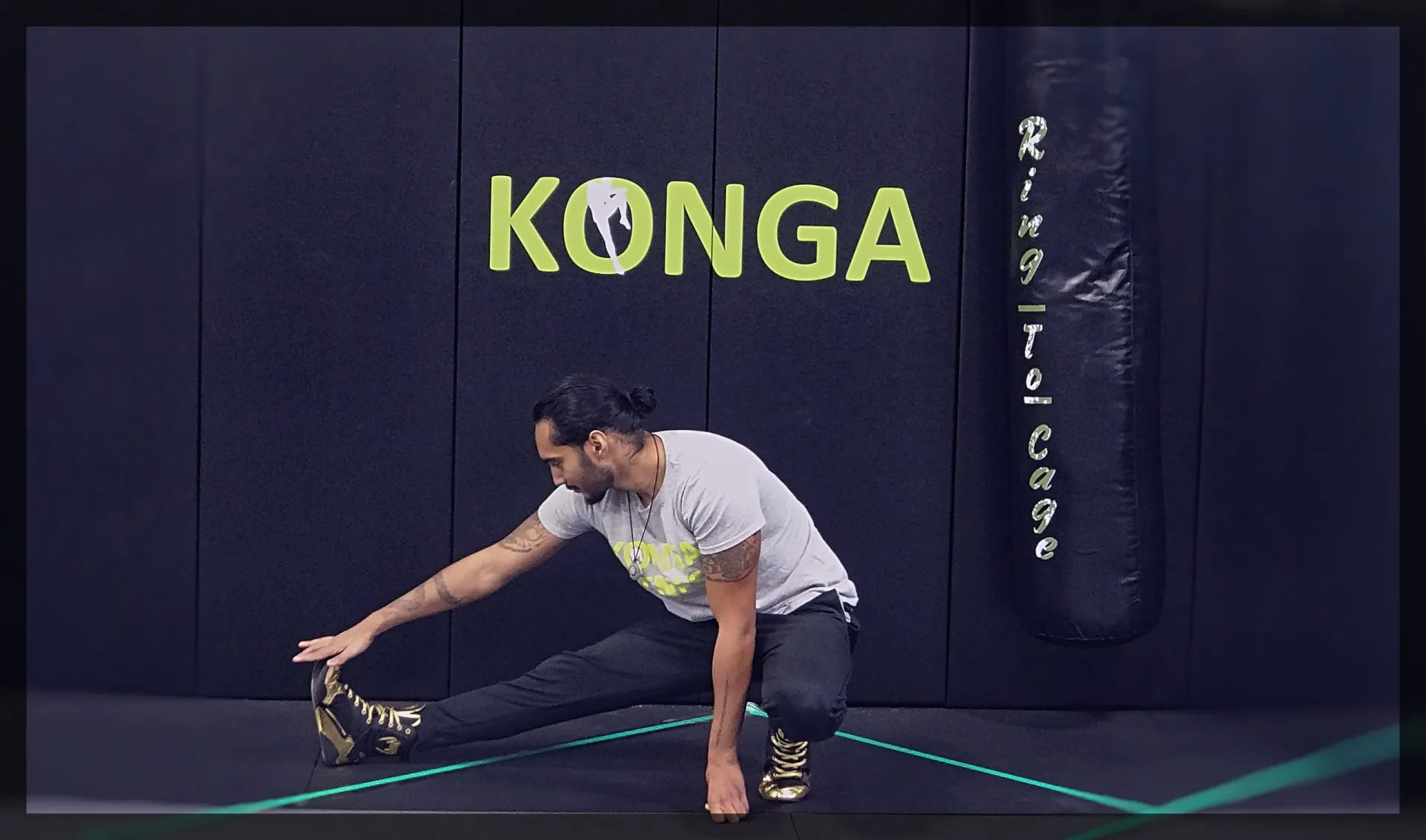 Man holding a deep side-lunge stretch on the mats