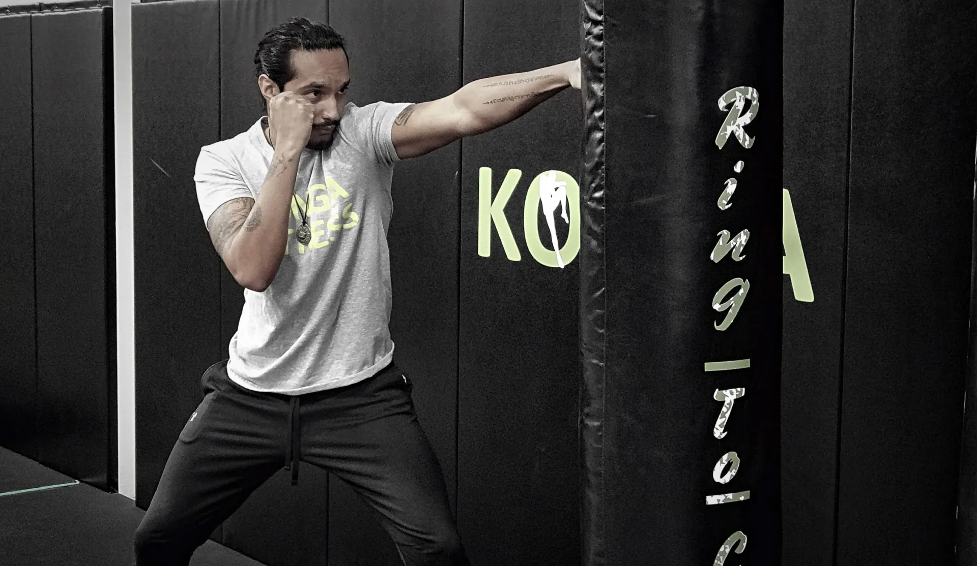 Man practising a punch beside a heavy bag at Konga Fitness