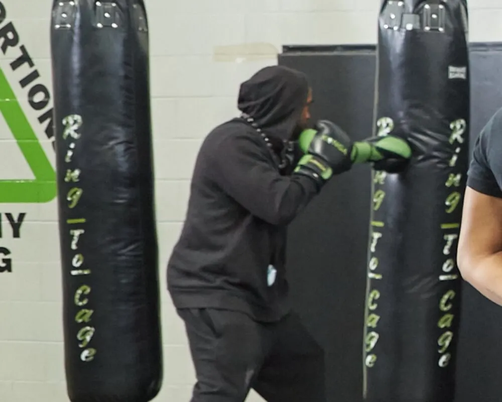 Member practising punches on a heavy bag
