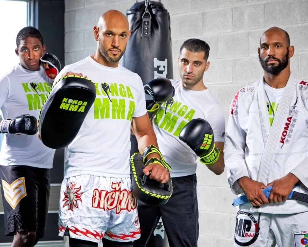 Martial arts coaches posing together with boxing pads