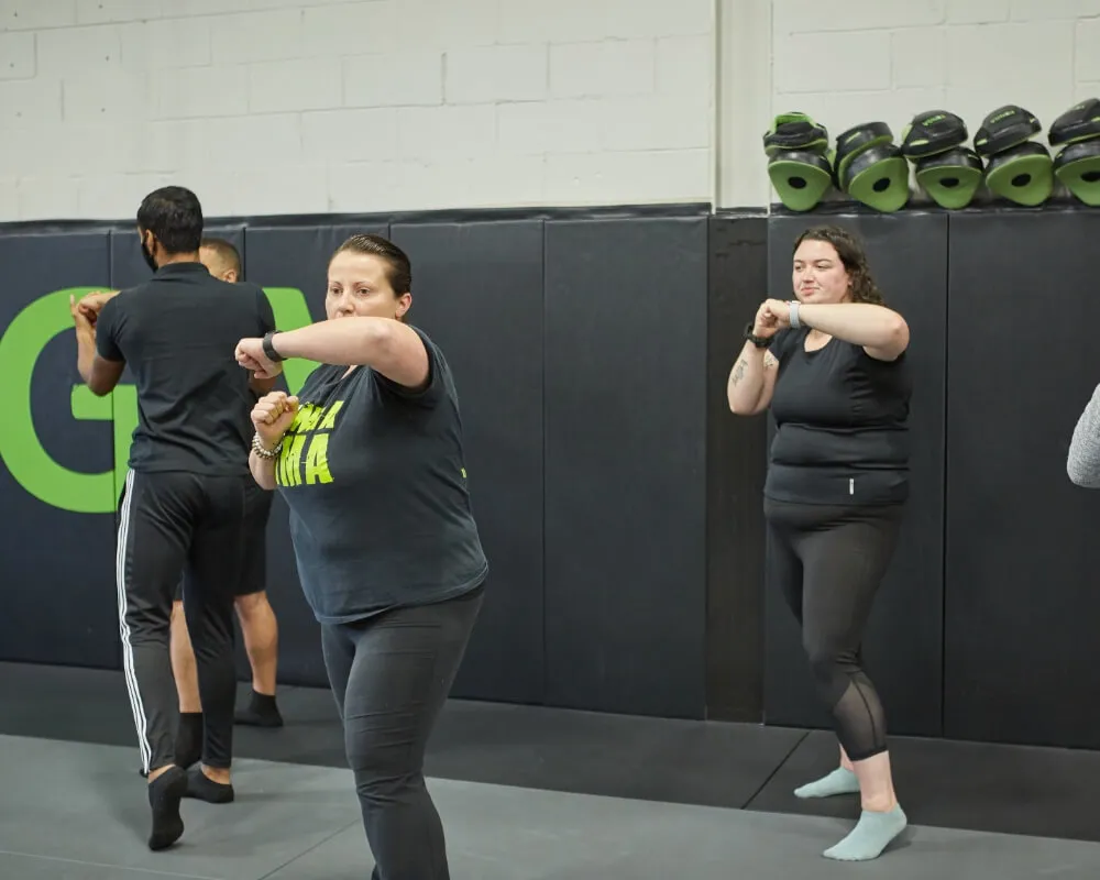 Women practising punches during a group class