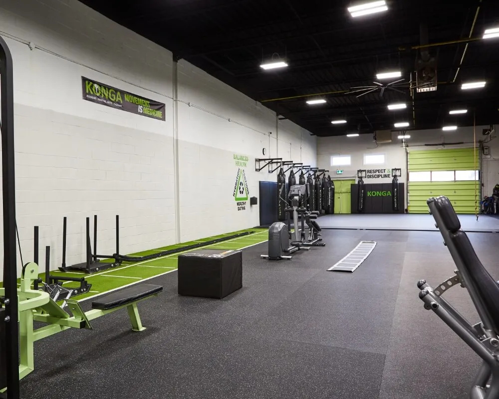 Konga Fitness training floor with turf, weights and punching bags