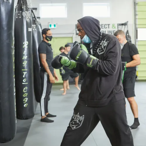 Konga members practising boxing beside punching bags