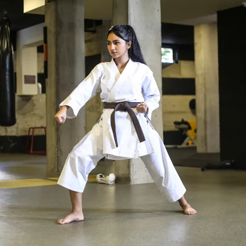 Woman in a martial arts uniform holding a wide stance