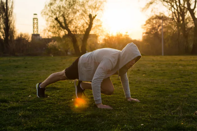 Person exercising on grass in the early morning