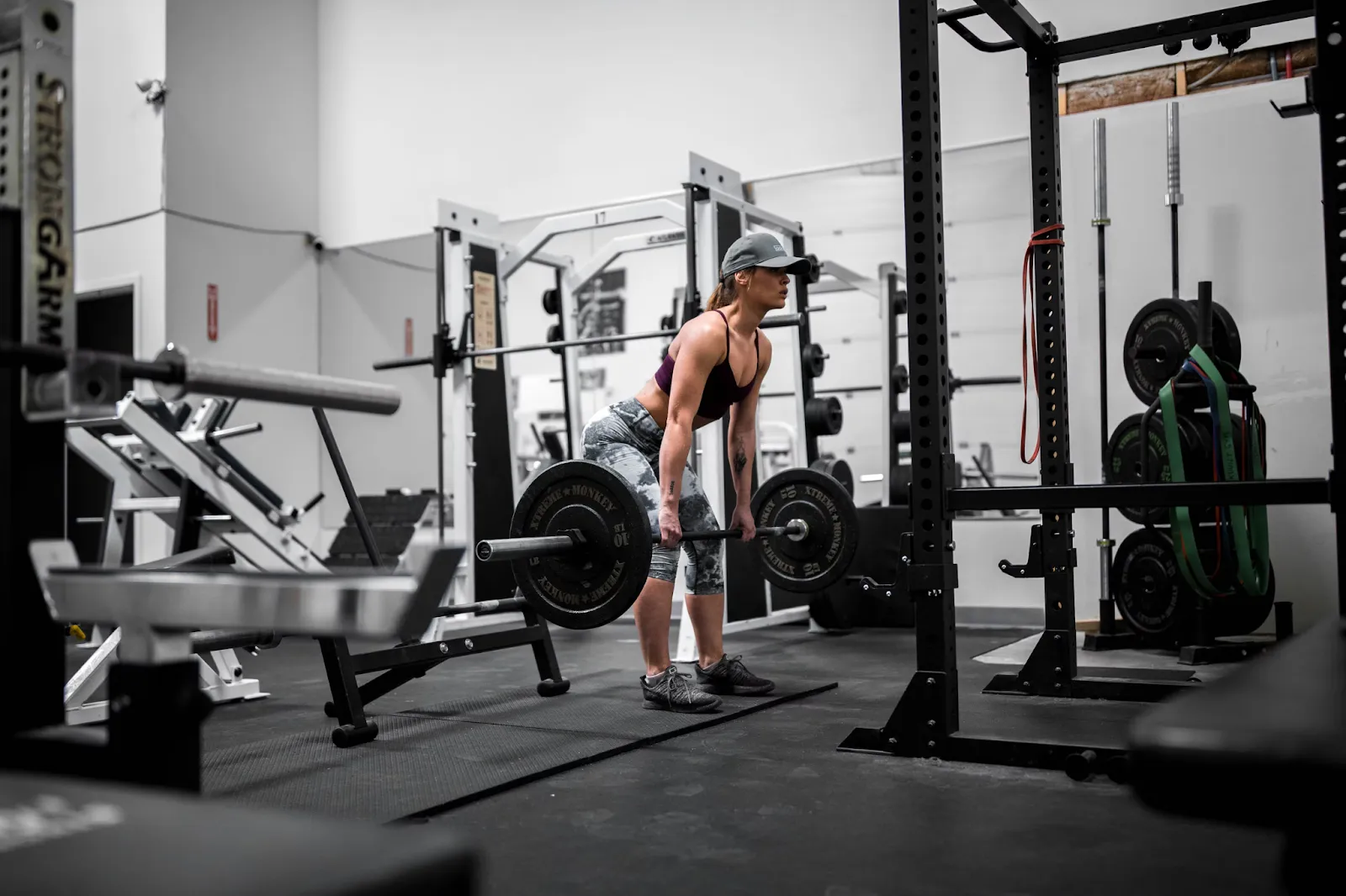 Member lifting a barbell in a weight-training area