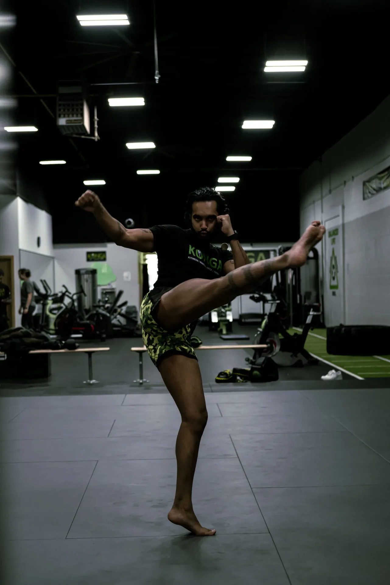 Member practising a high kick in the gym