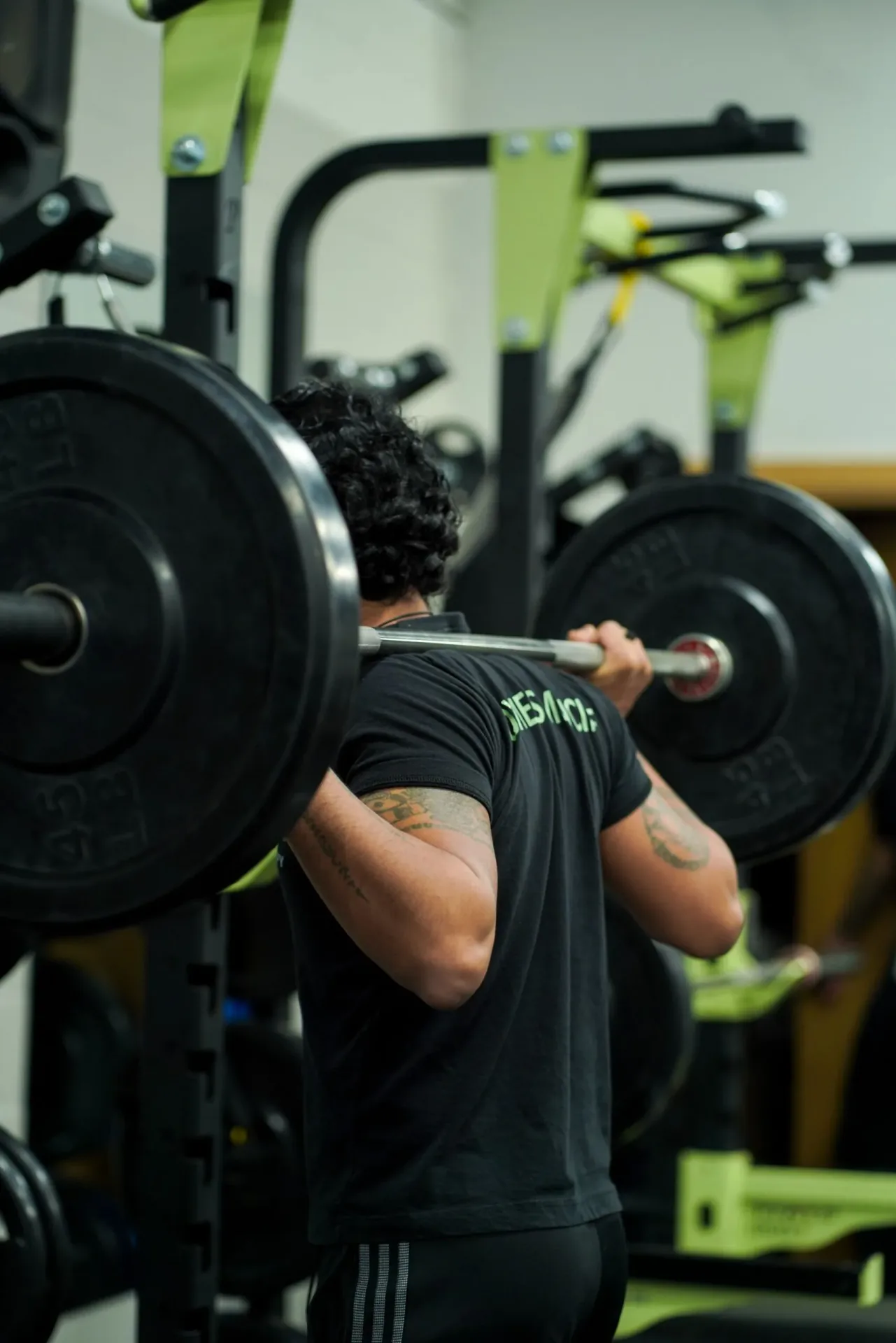 Member holding a barbell in the front-rack position