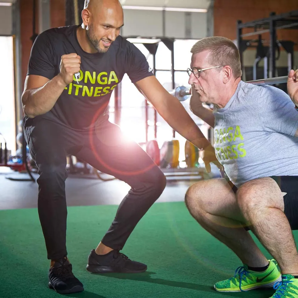 Khaled and Fahim demonstrating a squat exercise