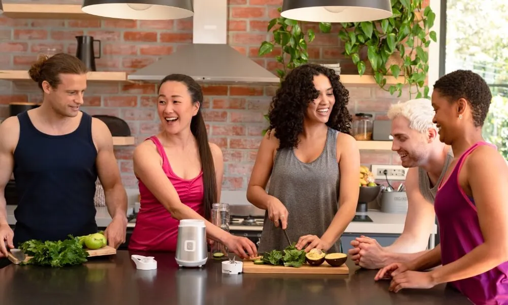 Friends preparing food together in a kitchen
