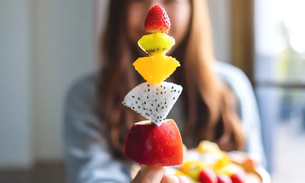 Skewer stacked with colourful pieces of fresh fruit
