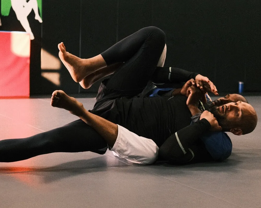 Two Brazilian Jiu-Jitsu students practising a ground hold