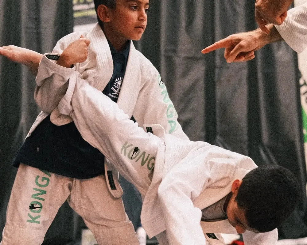 Children practising a Brazilian Jiu-Jitsu throw